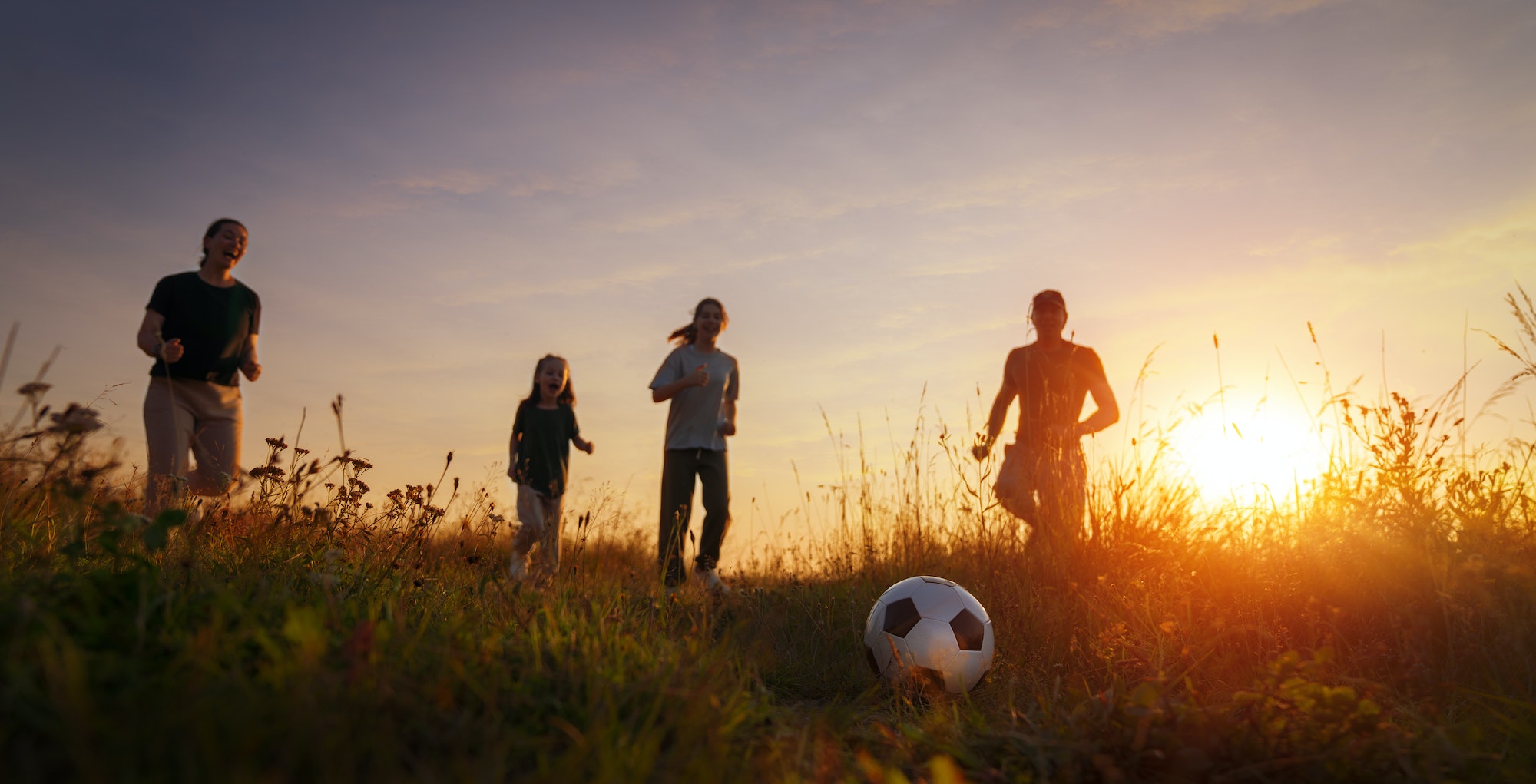 Happy family playing soccer